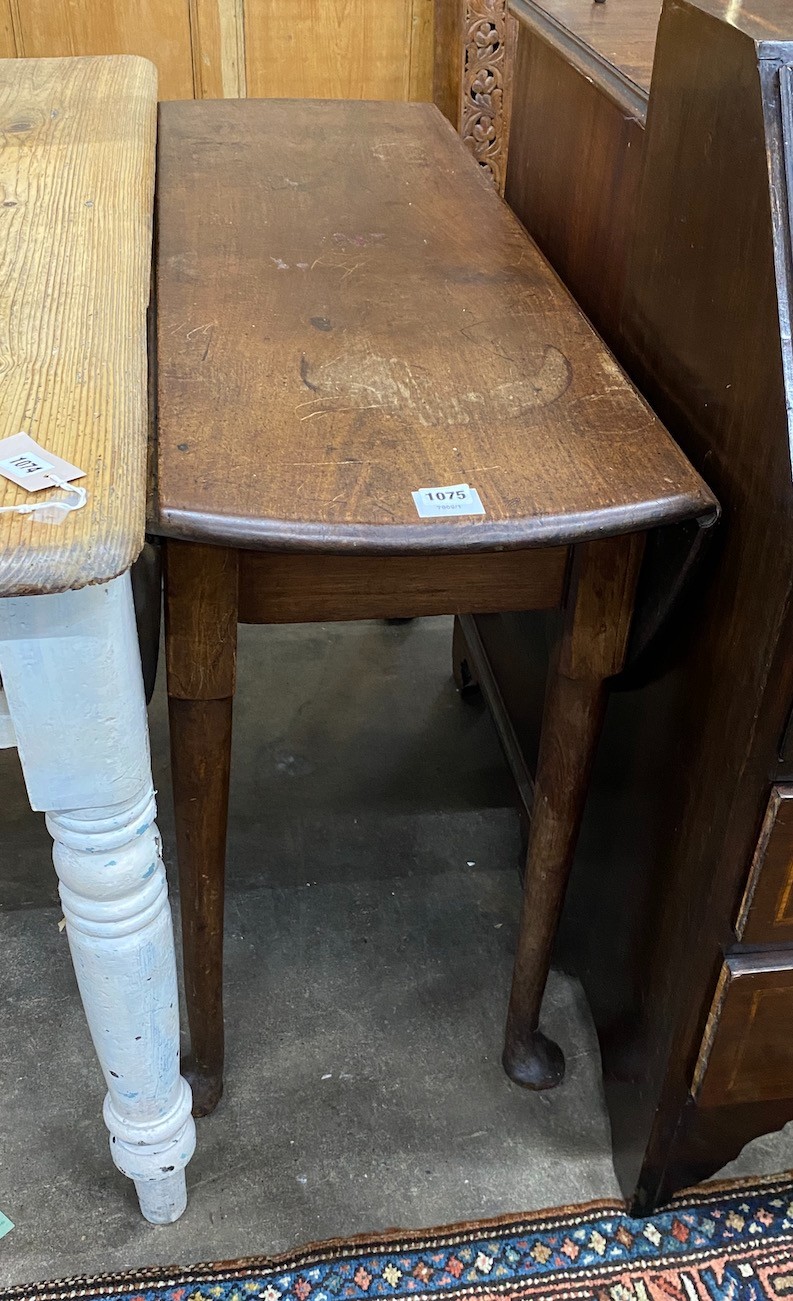 A George III mahogany drop leaf dining table with pad feet, width 106cm